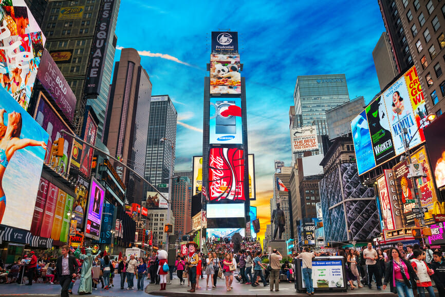 NEW YORK CITY - MAY 11: Times Square with tourists on May 11, 2013. Iconified as "The Crossroads of the World" it's the brightly illuminated hub of the Broadway Theater District.