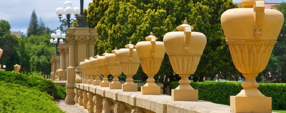 Row of tall urns sitting on railing at Stanford University