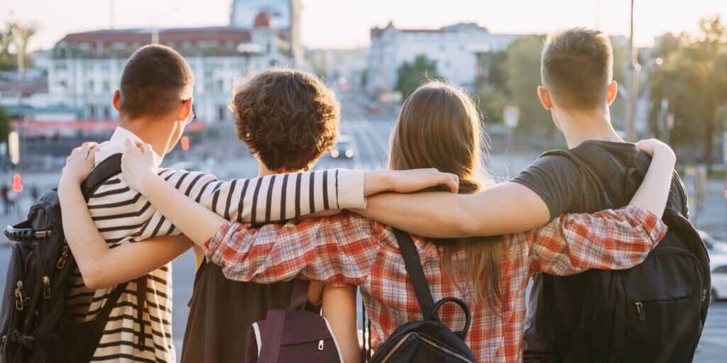 Students in the city with their arms around each other